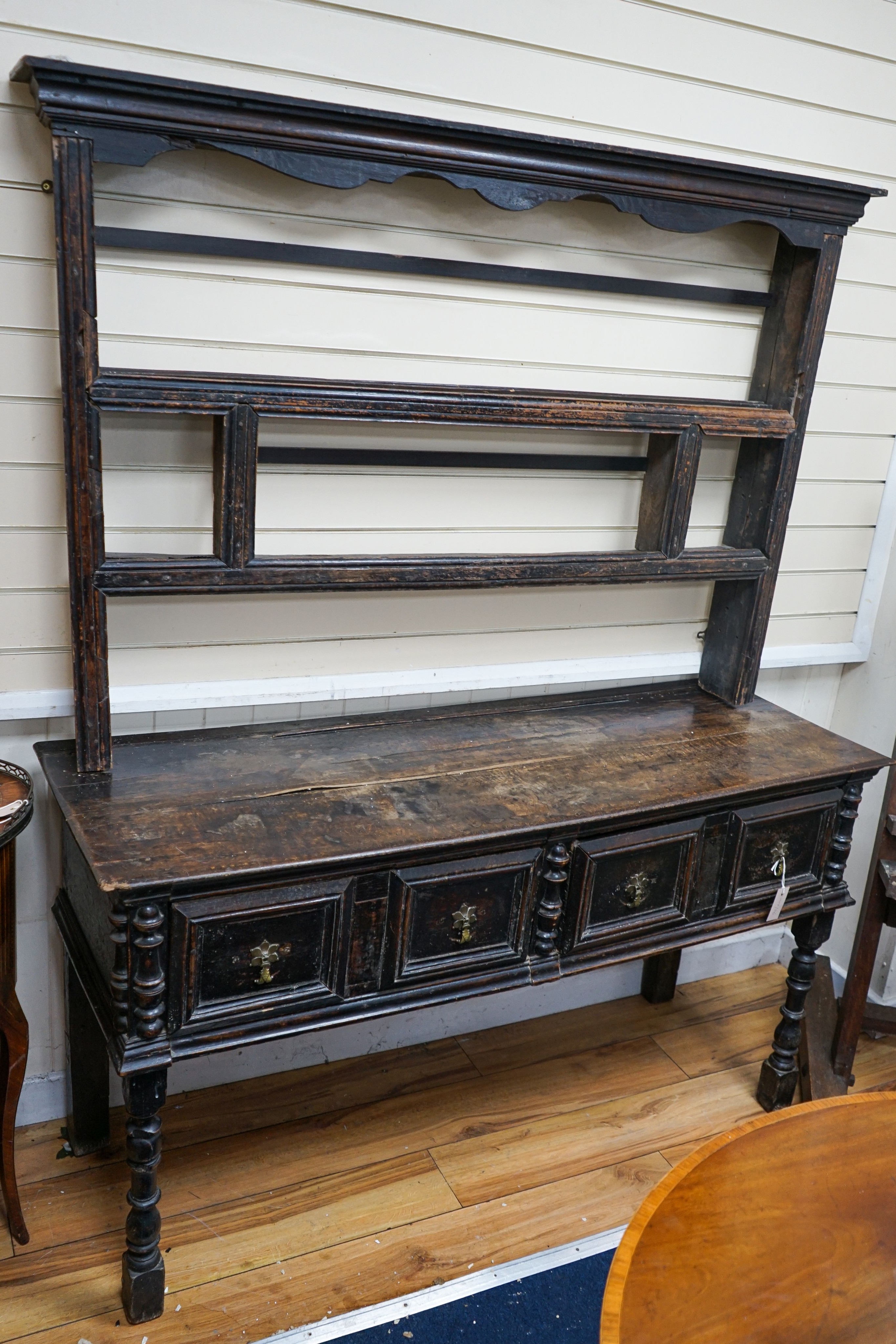 An 18th century and later oak dresser, the base fitted two drawers on turned supports, with two-tier plate rack over, width 147cm, depth 50cm, height 181cm